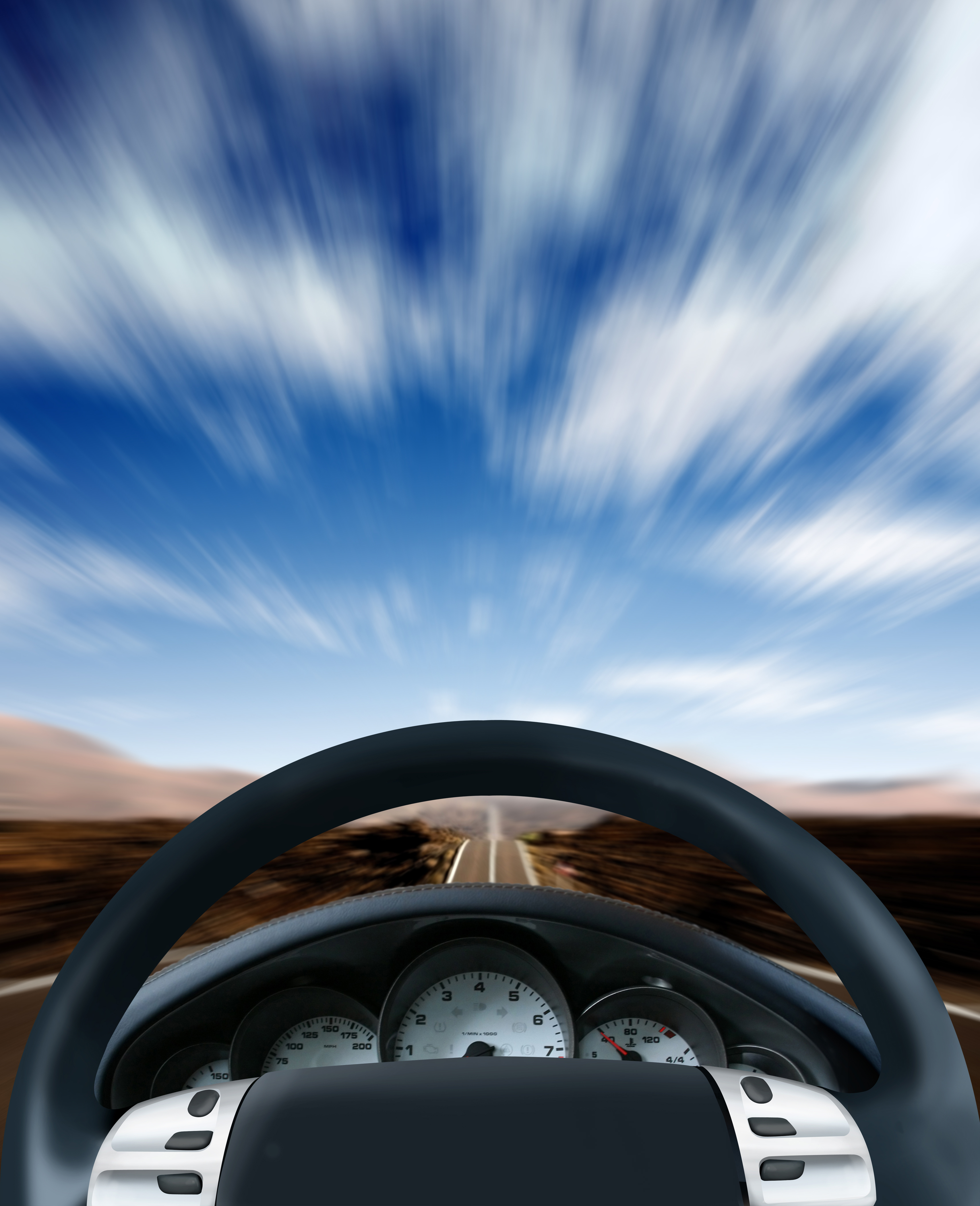 Steering wheel and dashboard of a car on a highway